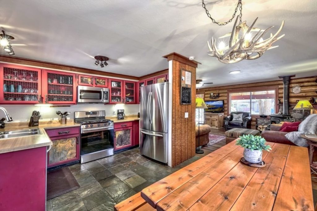 Log cabin kitchen with a cool antler chandelier in South Lake Tahoe