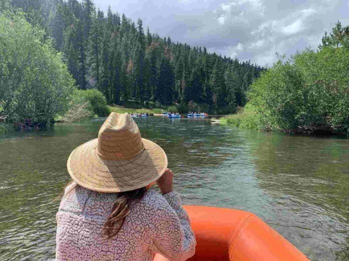 girl in a hat floating in a raft down the truckee river - Epic Lake Tahoe