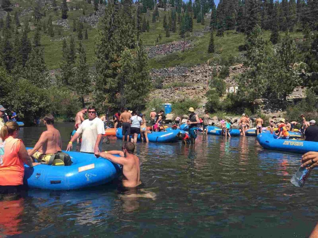 Group of people floating in blue rafts down the Truckee River