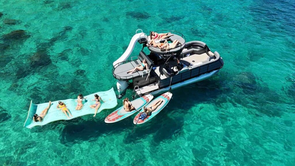 Double decker party boat on lake tahoe with a slide and upper level for sunbathing