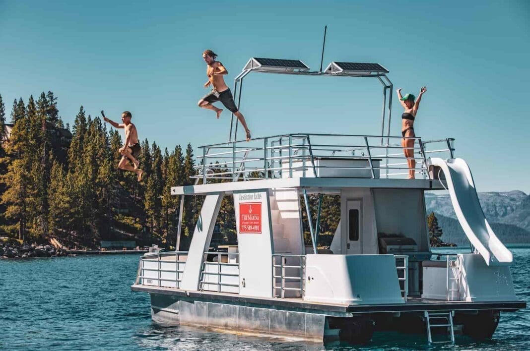 The Weekender pontoon boat at Zephyr Cove. People jumping off the top of the boat into the lake.