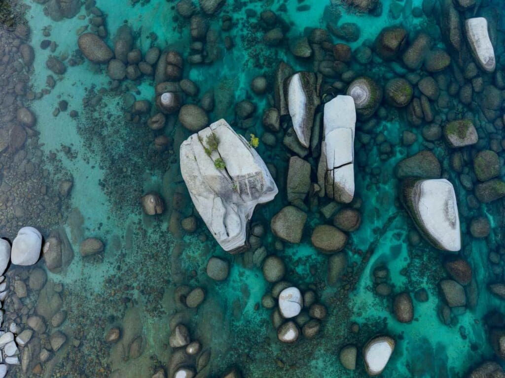 Lake Tahoe aerial view of the water. Crystal clear with boulders